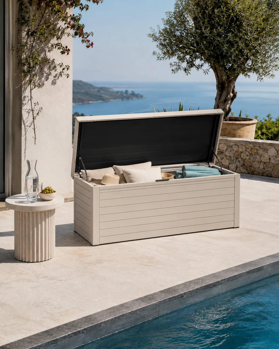Outdoor storage box open near pool with towels and cushions